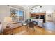 Dining area with a view of the outdoor scenery and access to a kitchen with black appliances at 87 Elmgreen Ln, Evergreen, CO 80439