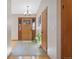 Inviting entryway featuring a wooden front door, chandelier, and tile flooring at 87 Elmgreen Ln, Evergreen, CO 80439