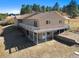 Two-story home with a spacious wraparound deck and outdoor living space at 87 Elmgreen Ln, Evergreen, CO 80439