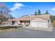 Charming ranch style home featuring a two-car garage, covered porch, and beautiful landscaping at 87 Elmgreen Ln, Evergreen, CO 80439