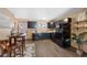 Eat-in kitchen with black appliances, wood floor, and an adjacent dining space at 87 Elmgreen Ln, Evergreen, CO 80439