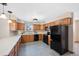 Well-lit kitchen with oak cabinets and modern black appliances at 87 Elmgreen Ln, Evergreen, CO 80439