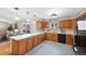 Well-lit kitchen with wood cabinets, white countertops, and access to a dining area at 87 Elmgreen Ln, Evergreen, CO 80439