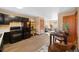 Open-concept kitchen with adjacent dining and sitting room with hardwood floors at 87 Elmgreen Ln, Evergreen, CO 80439