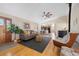 Open-concept living room showcasing hardwood floors, modern decor, and a view into the kitchen at 87 Elmgreen Ln, Evergreen, CO 80439
