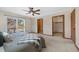 Large carpeted bedroom with ceiling fan, balcony door, and walk-in closet at 87 Elmgreen Ln, Evergreen, CO 80439