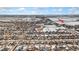 An aerial view shows a community near the Bella Rosa Golf Course amidst a snowy landscape under a blue sky at 9121 Harlequin Cir, Frederick, CO 80504