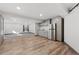 Finished basement with stainless steel refrigerator, vinyl flooring and adjoining carpeted room at 9121 Harlequin Cir, Frederick, CO 80504