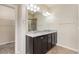 Elegant bathroom features a dual sink vanity with granite countertop, and a glass-enclosed shower at 9121 Harlequin Cir, Frederick, CO 80504
