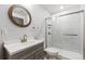 Updated bathroom features include a gray vanity, brushed nickel faucet and sliding glass shower door at 9121 Harlequin Cir, Frederick, CO 80504