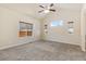 Bright and airy bedroom with neutral carpeting, large windows, and a view of the outdoors at 9121 Harlequin Cir, Frederick, CO 80504
