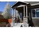Charming front porch with stone accents, blooming tree, and well-maintained landscaping enhance curb appeal at 9121 Harlequin Cir, Frederick, CO 80504