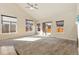 Large, sunlit living room with vaulted ceilings and a sliding glass door to the outdoor space at 9121 Harlequin Cir, Frederick, CO 80504