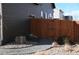 Side yard featuring a wooden fence, rock bed, and walkway leading to a gate at 9121 Harlequin Cir, Frederick, CO 80504