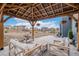 Backyard space featuring a patio with outdoor furniture, pergola, and open grassy area at 510 W Prestwick Way, Castle Rock, CO 80104