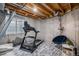 Unfinished basement fitness area with a treadmill, exposed ceiling, and concrete walls at 510 W Prestwick Way, Castle Rock, CO 80104