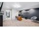 Finished basement featuring black accent wall, desk, chair and view into adjacent bedroom at 510 W Prestwick Way, Castle Rock, CO 80104