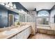 Gorgeous bathroom features a double vanity, soaking tub, separate shower, and plenty of natural light at 510 W Prestwick Way, Castle Rock, CO 80104