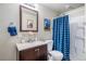 Bathroom featuring a vanity with stylish finishes, framed mirror and tub with blue shower curtain at 510 W Prestwick Way, Castle Rock, CO 80104