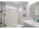 Bathroom featuring white subway tile, shower-tub combo and gray vanity with animal themed wall art at 510 W Prestwick Way, Castle Rock, CO 80104