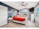 Serene bedroom showcases a stylish ceiling fan, large window, and blue accent wall for a calm retreat at 510 W Prestwick Way, Castle Rock, CO 80104