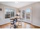 Bright dining area with wood floors, large windows, and French doors leading to outdoor spaces at 510 W Prestwick Way, Castle Rock, CO 80104