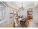 Bright dining room with a stylish chandelier, large table setting, and a view into the adjacent kitchen at 510 W Prestwick Way, Castle Rock, CO 80104