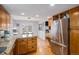 Well-lit kitchen with stainless steel fridge, eat-in dining, and granite countertops provides for easy entertaining at 510 W Prestwick Way, Castle Rock, CO 80104