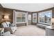 Inviting living room with neutral tones, two large windows, comfortable seating, and a relaxing ambiance at 510 W Prestwick Way, Castle Rock, CO 80104