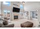 Spacious living room featuring a fireplace, large windows, neutral decor and seamless connection to other rooms at 510 W Prestwick Way, Castle Rock, CO 80104