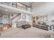 Bright living room with high ceilings, large windows, neutral décor and elegant staircase to the second floor at 510 W Prestwick Way, Castle Rock, CO 80104