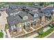 An aerial view highlights the townhome's balcony, gray siding, and well-maintained landscaping at 5179 S Fairplay St, Aurora, CO 80015