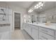 Bright bathroom with double vanity, tiled shower, and walk-in closet at 5179 S Fairplay St, Aurora, CO 80015