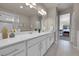 Bathroom with double vanity, white cabinets, and tile flooring at 5179 S Fairplay St, Aurora, CO 80015