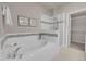 Luxurious bathroom with a soaking tub, a separate glass-enclosed shower, and neutral decor at 5179 S Fairplay St, Aurora, CO 80015