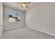 Bedroom with neutral colored walls, carpet flooring, and large window at 5179 S Fairplay St, Aurora, CO 80015