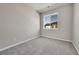 Bedroom with a large window, neutral colored walls and carpet flooring at 5179 S Fairplay St, Aurora, CO 80015