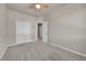 Bedroom with closet and ceiling fan, featuring neutral colored carpet and walls at 5179 S Fairplay St, Aurora, CO 80015