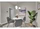 Modern dining area featuring a round table with stylish chairs, a contemporary light fixture, and neutral decor at 5179 S Fairplay St, Aurora, CO 80015