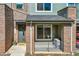 Charming townhouse with brick accents, gray siding, covered porch, and manicured landscaping at 5179 S Fairplay St, Aurora, CO 80015