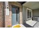 Charming brick front porch with modern door, stylish hardware, and a 'Welcome Home' mat at 5179 S Fairplay St, Aurora, CO 80015