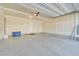 Spacious two-car garage with sealed concrete floors, white walls, and ample overhead lighting at 5179 S Fairplay St, Aurora, CO 80015