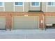 Attached garages with updated doors and exterior brick finishes blend seamlessly at 5179 S Fairplay St, Aurora, CO 80015