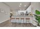 Kitchen and breakfast bar featuring seating for four with modern stools and bright, white accents at 5179 S Fairplay St, Aurora, CO 80015