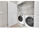 Bright laundry room features modern washer and dryer units and plenty of storage space at 5179 S Fairplay St, Aurora, CO 80015