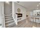 Open-concept living room showcasing a staircase, fireplace, and breakfast bar seating at 5179 S Fairplay St, Aurora, CO 80015