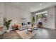 Bright and airy living room featuring a comfortable sofa and large windows at 5179 S Fairplay St, Aurora, CO 80015