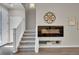 Inviting living room featuring a staircase, fireplace, and stylish decor at 5179 S Fairplay St, Aurora, CO 80015