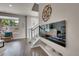 Open living area featuring a sleek fireplace, neutral tones, and sunlit window at 5179 S Fairplay St, Aurora, CO 80015