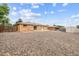 Spacious backyard with low maintenance gravel ground cover, offering a clean and functional outdoor space at 8460 Corona St, Denver, CO 80229